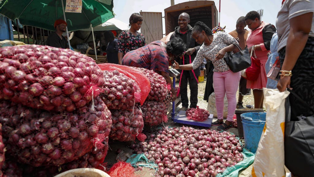 People buying onions at an open market in Nairobi, Kenya, on 12 September 2023. 
