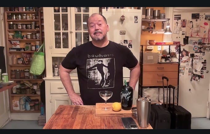 Alex Chee stands in his kitchen in front of martini ingredients