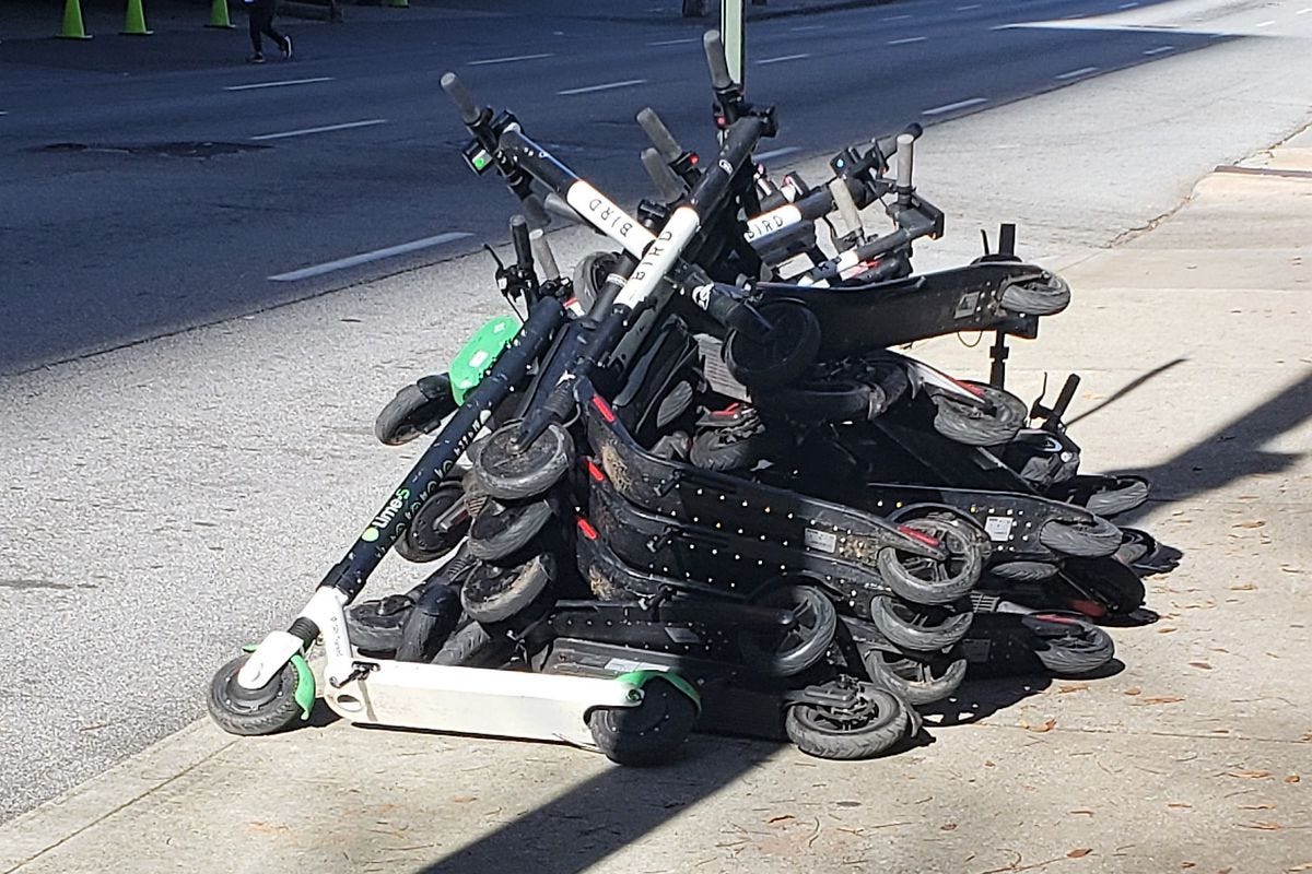 a picture of e-scooters in a pile a picture of e-scooters in a pile