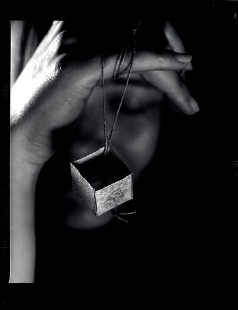 silver and gold boxes hung on string