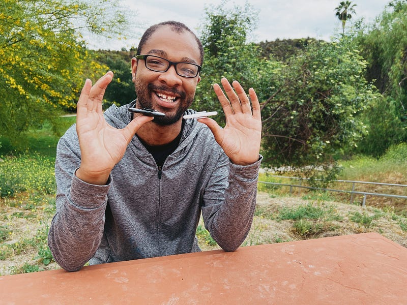 a man balancing 2 phones on his thumbs