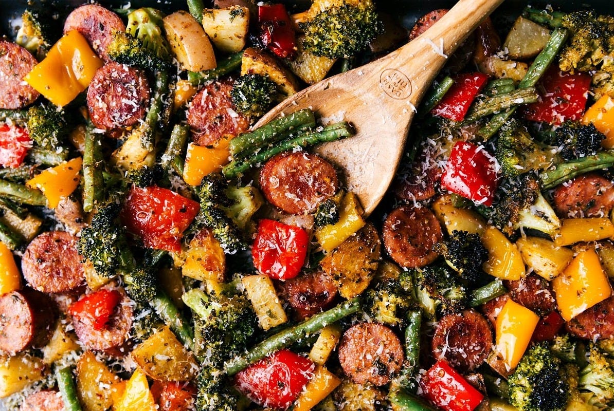 Perfectly cooked and seasoned sheet pan sausage and vegetables, ready for serving.
