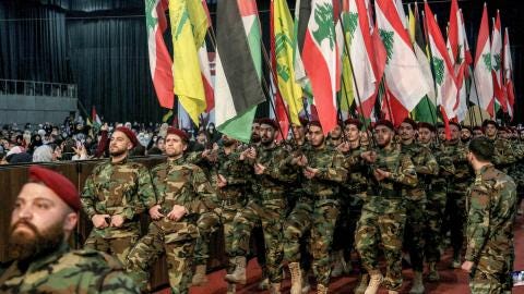 Pro-Iranian Hezbollah militants march with Lebanese, Palestinian, and Hezbollah flags during a mass rally to mark al-Quds Day (Jerusalem Day). (Marwan Naamani/picture alliance via Getty Images) Pro-Iranian Hezbollah militants march with Lebanese, Palestinian, and Hezbollah flags during a mass rally to mark al-Quds Day (Jerusalem Day). (Marwan Naamani/picture alliance via Getty Images)