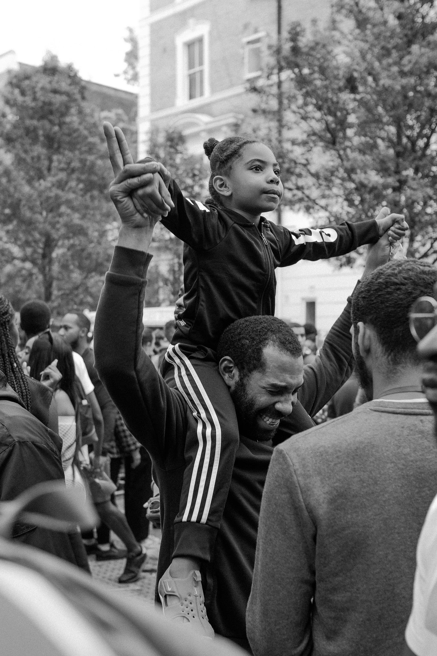 Black Child on Man's shoulders