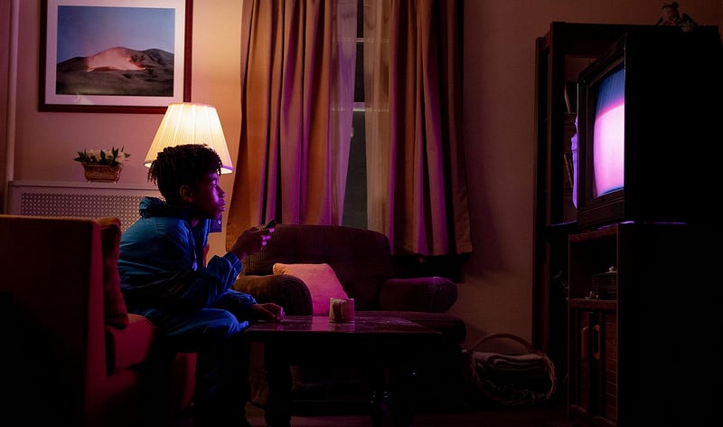 Protagonist of ‘I Saw the TV Glow’ looking toward a TV with awe in his eyes
