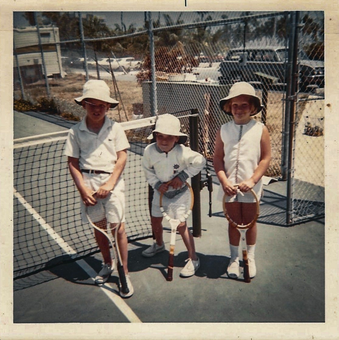 Three kids in 70s tennis attire courtside Three kids in 70s tennis attire courtside