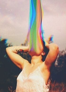 This may contain: a woman with colorful hair is standing in the grass and has her hands behind her head