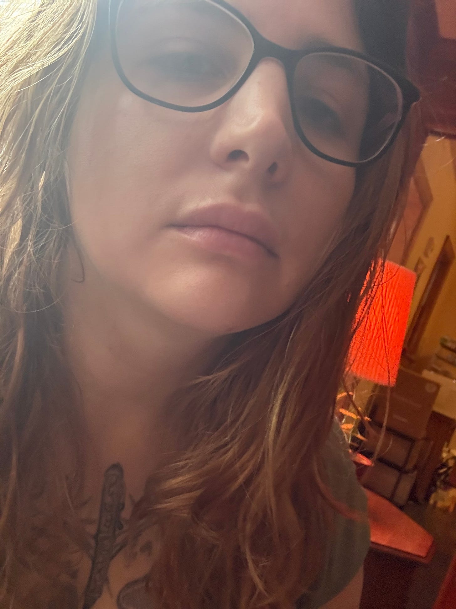 zoomed in pic of a white girl with black emo glasses as the sun beats down on her hair.. a selfie from a depressed girl
