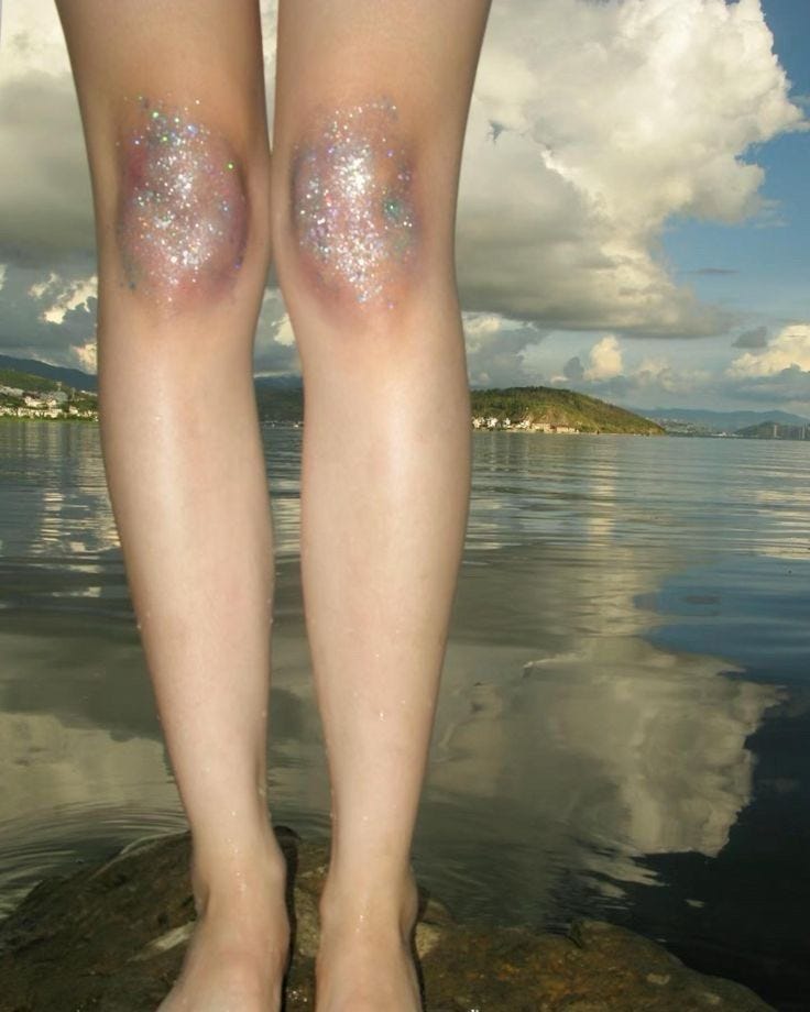 This may contain: the legs and ankles of a person standing on rocks near water with clouds in the background