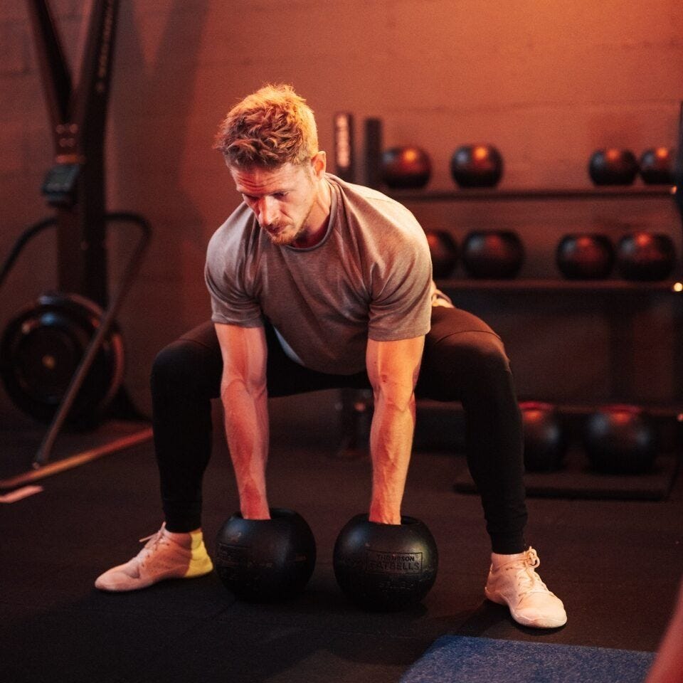Participant lifting weights during a group training class at Episod in Paris Participant lifting weights during a group training class at Episod in Paris
