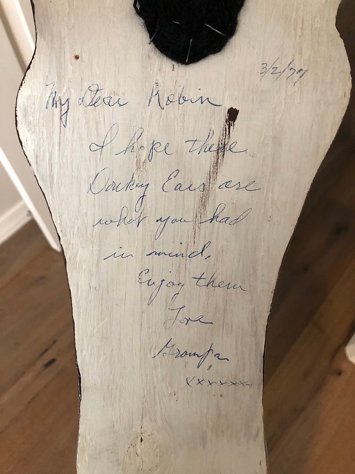A painted wooden donkey, a note from grampa on the back dated 1977.