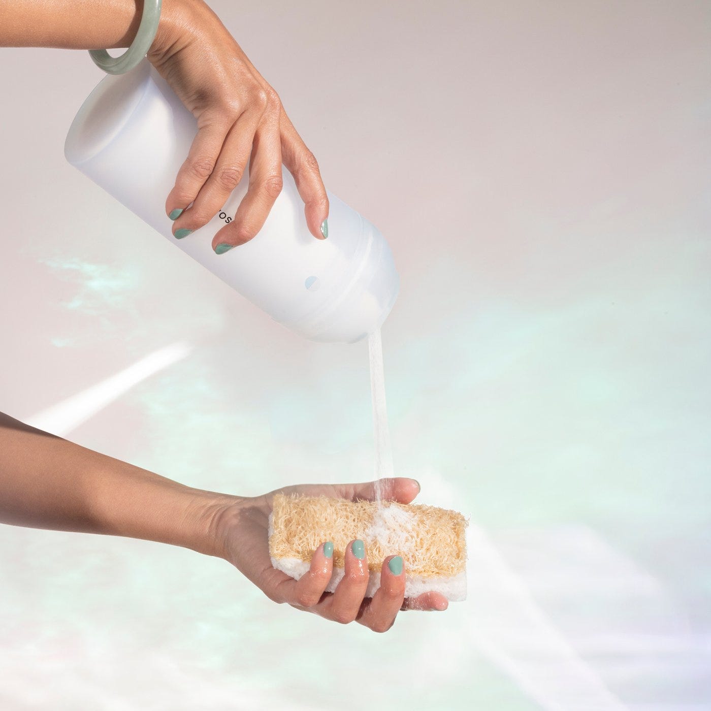 Powder Dish Soap poured onto biodegradable sponge with pink background Powder Dish Soap poured onto biodegradable sponge with pink background