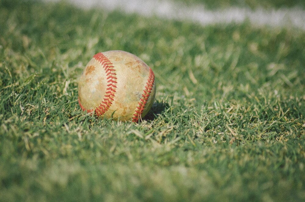 Baseball in the outfield (Credit: Matthew T Rader / Unsplash)