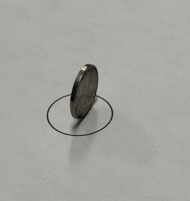 A coin on a piece of paper

AI-generated content may be incorrect.