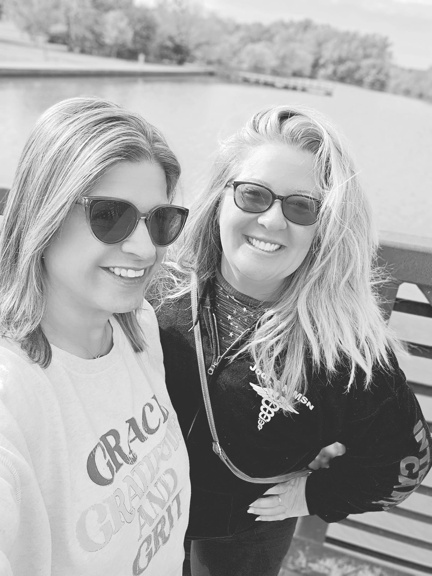 May be a black-and-white image of 2 people, blonde hair and people smiling