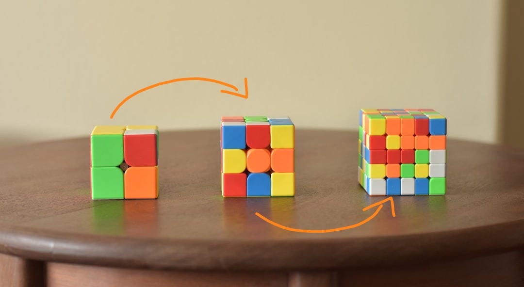 a wooden table topped with three different colored blocks