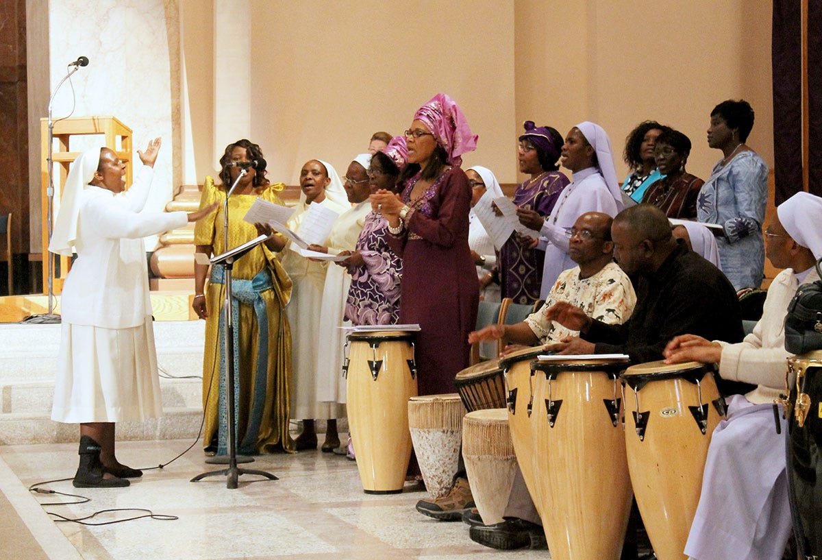 Lay musicians pound tall hand drums in a post-Vatican II Catholic worship service.
