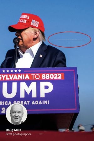 Bullet streaking past Trump.