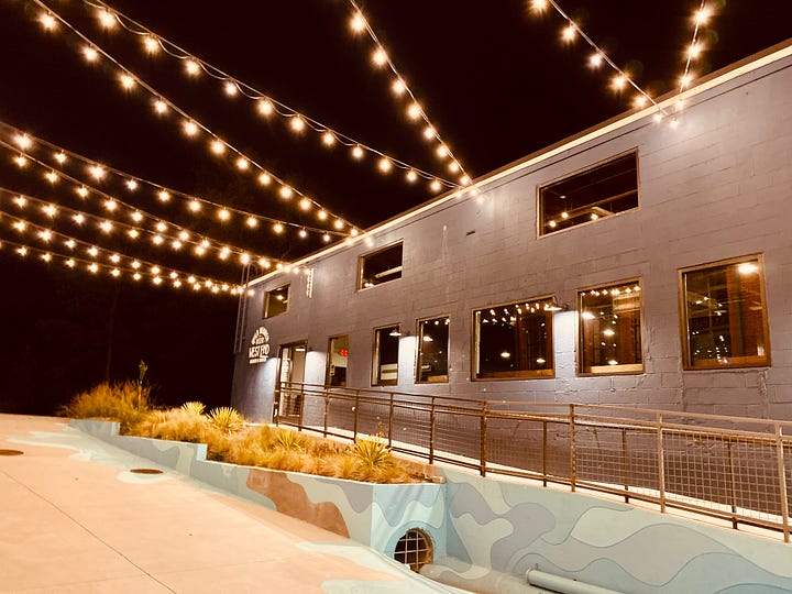 signs, lights, tables, chairs, sky