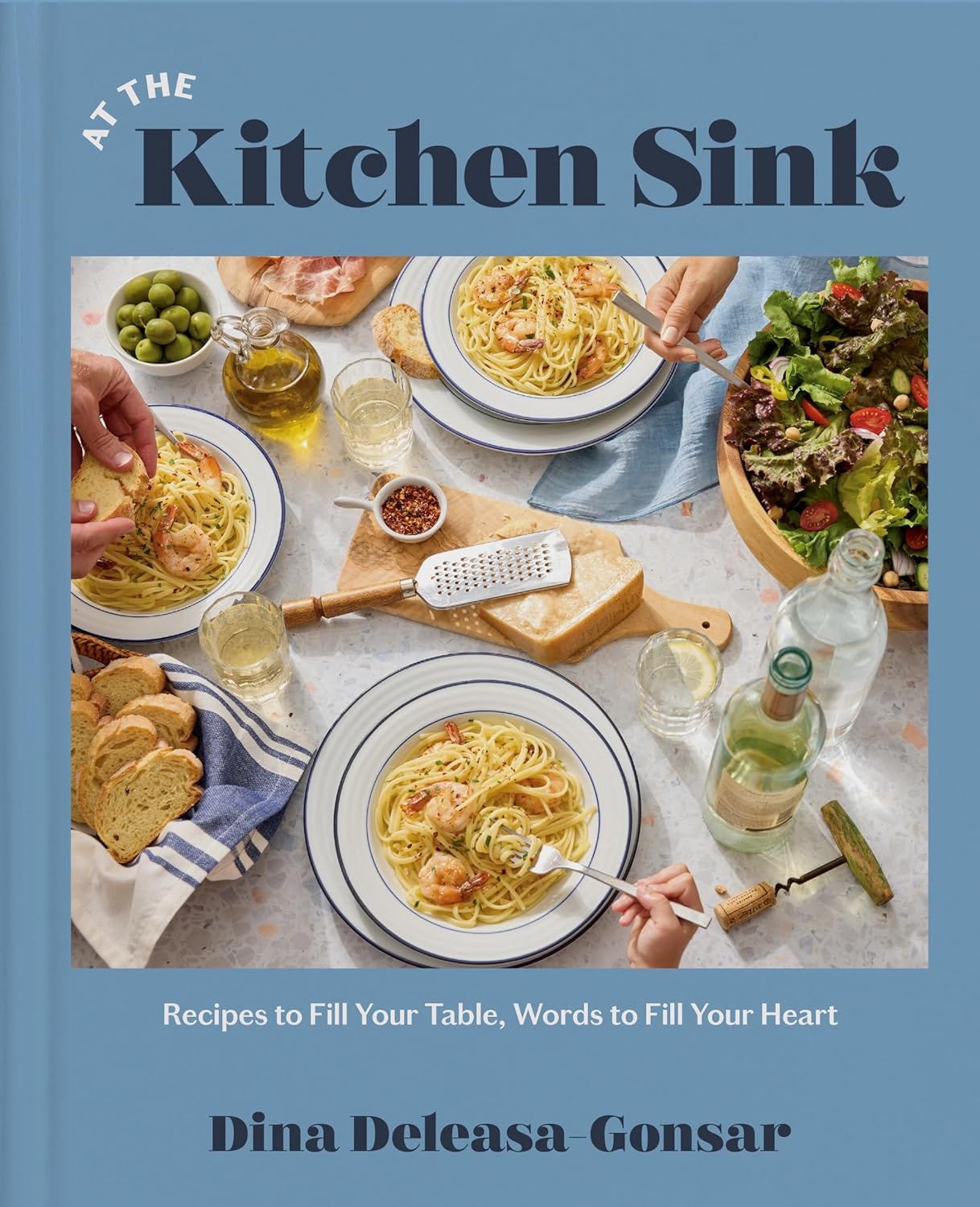 The book cover of At the Kitchen Sink: Recipes to Fill Your Table, Words to Fill Your Heart; A Cookbook The book cover of At the Kitchen Sink: Recipes to Fill Your Table, Words to Fill Your Heart; A Cookbook