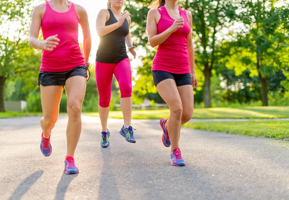 group of healthy girls running outdoors at sunset with lens flare. group of healthy girls running outdoors at sunset with lens flare.