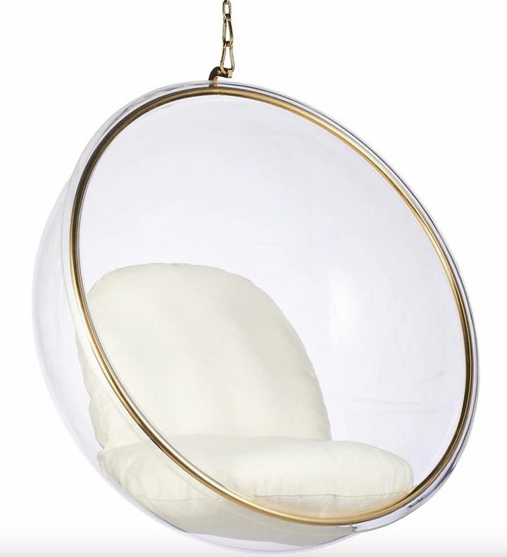 bubble chairs, on standing and one hanging with cream seated cushioj