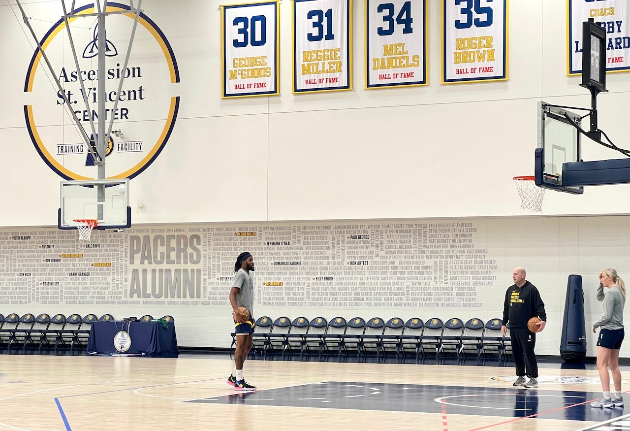 Jim Boylen works with center Isaiah Jackson after practice.