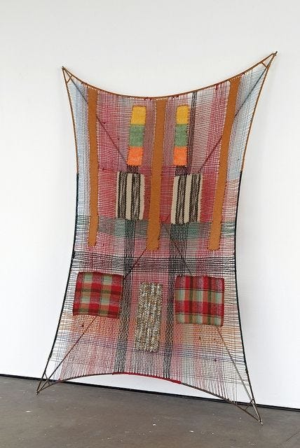 This may contain: a piece of art that is hanging up on the wall with some kind of fabric