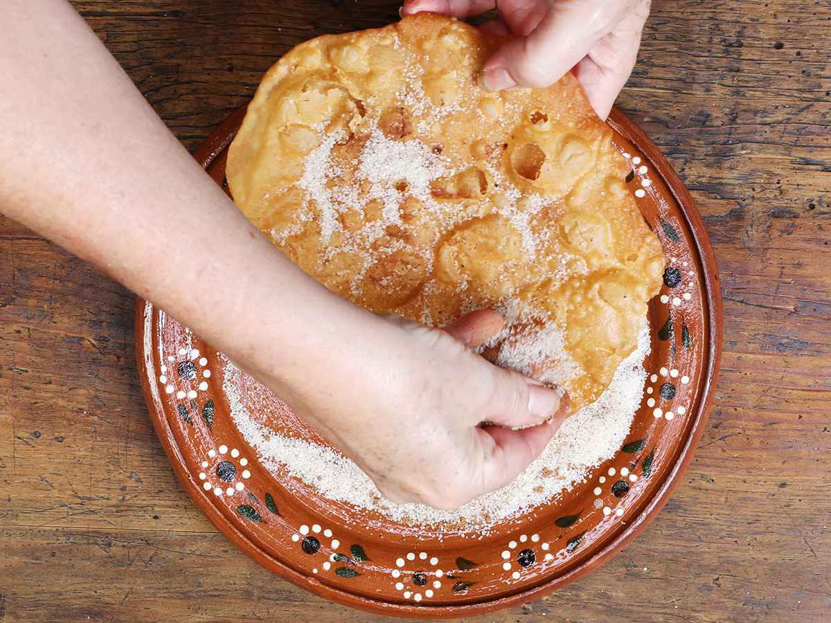 Dusting Buñuelos with Sugar