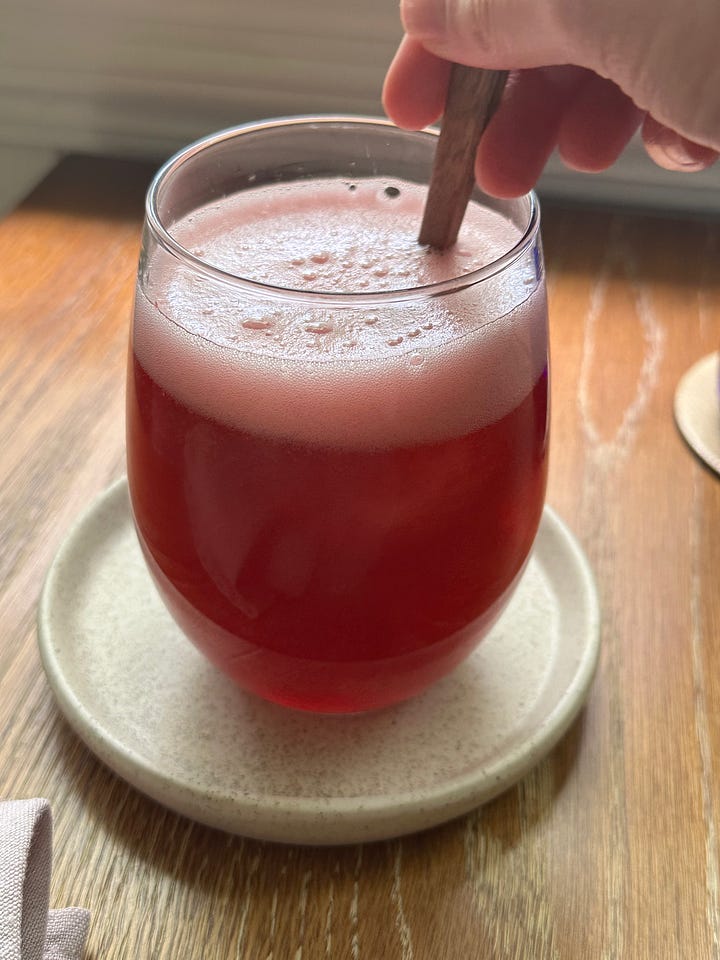 blackberry simple syrup pouring into glass and soda on the right when mixed with seltzer water