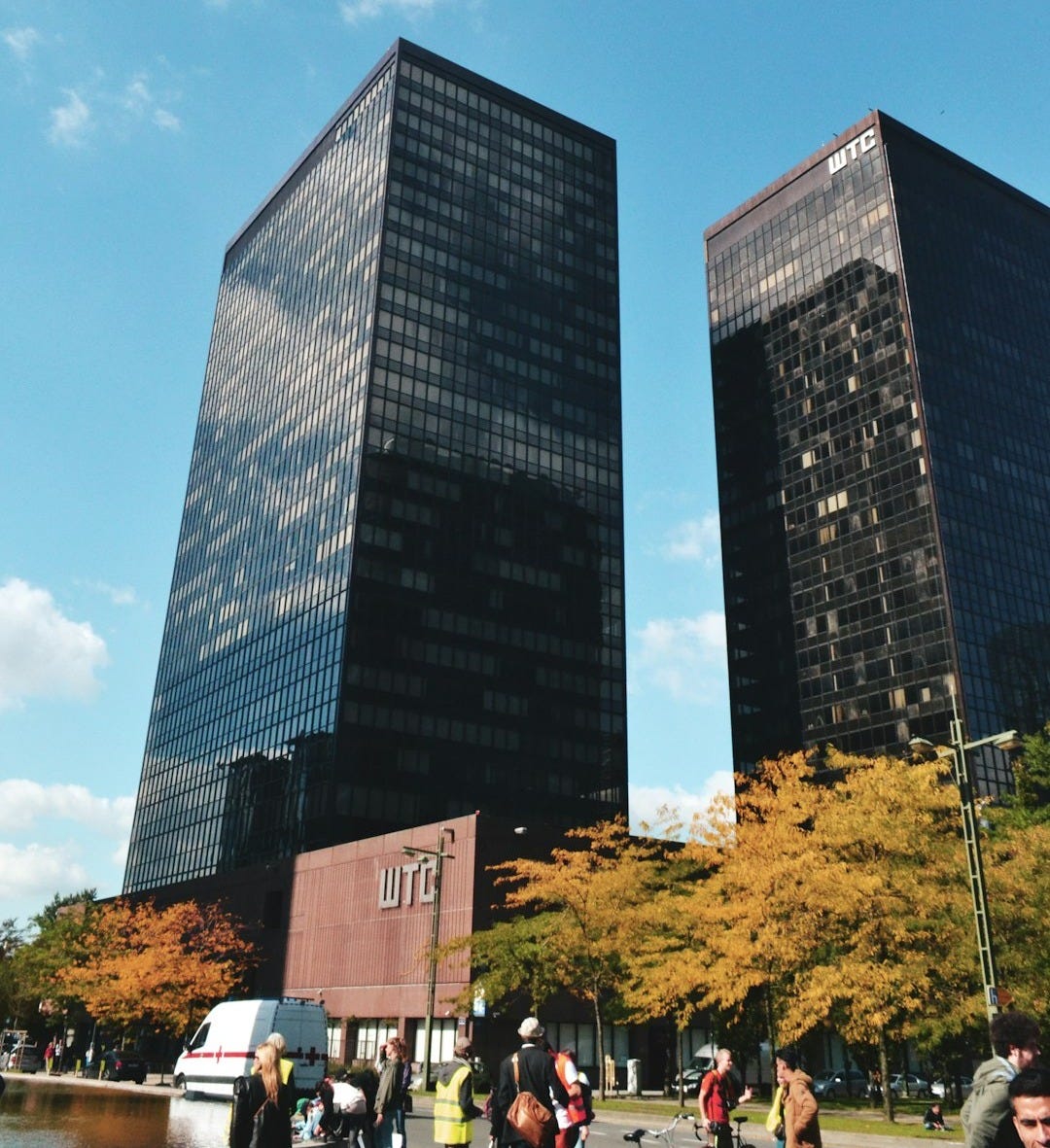 low angle photography of two black curtain high-glass buildings during daytime low angle photography of two black curtain high-glass buildings during daytime