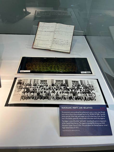 Image 1: Black and white panoramic photos documenting American history through the 70's|| My Apple Watch that I bought from the Carnegie Store|| Opened copy of Fourth Wing while I was reading it || An old Panoramic camera|| Negative film of a photo lined up with it's print|| the welcome area at the Apple store where people learn about Apple products