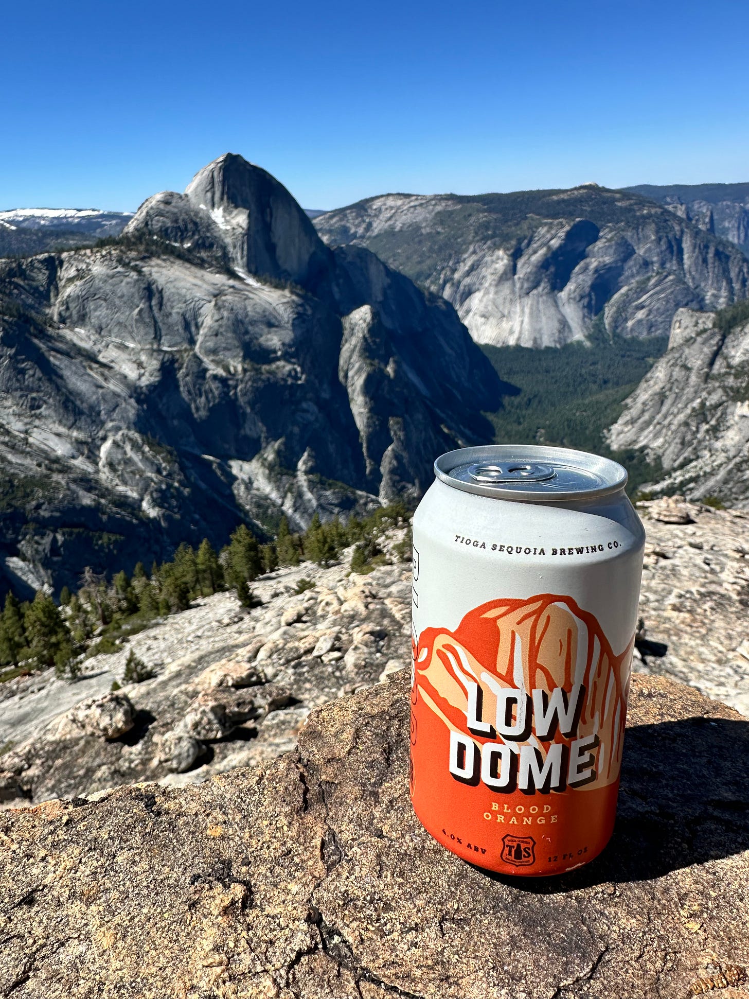 A can of Tioga Sequoia "Low Dome" beer while Half Dome in Yosemite National Park is in the background A can of Tioga Sequoia "Low Dome" beer while Half Dome in Yosemite National Park is in the background