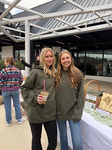 Lots of people holding a green smoothie at an in-person event for Grace & Greens