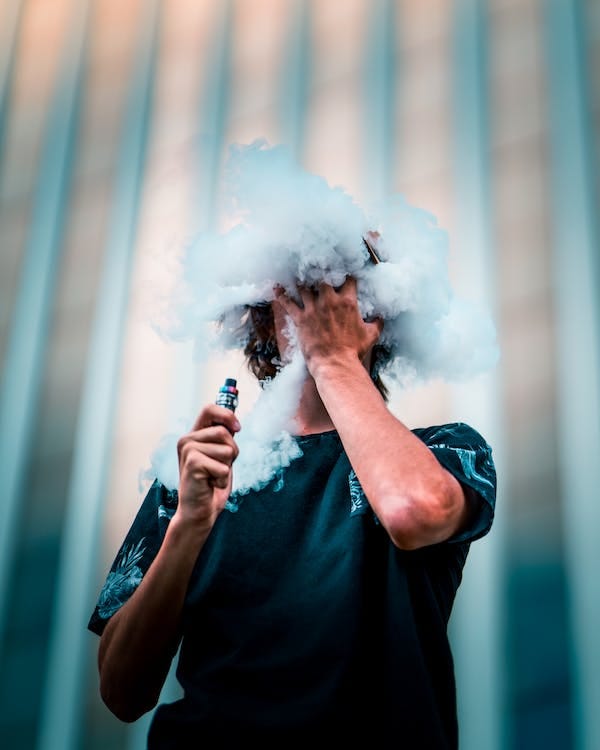 Free Selective Focus Photography Of Man Doing Vape Trick Stock Photo