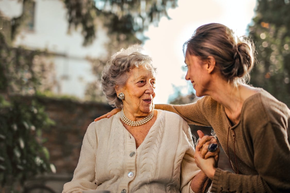 Free Joyful adult daughter greeting happy surprised senior mother in garden Stock Photo Free Joyful adult daughter greeting happy surprised senior mother in garden Stock Photo