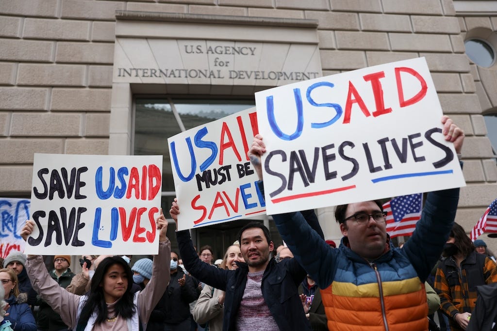 (Tierney L. Cross | The New York Times) People demonstrate in support of of the U.S. Agency for International Development outside its headquarters in Washington, on Monday, Feb. 3, 2025. The U.S. Agency for International Development is in crisis as workers report being locked out, adding to the growing sense that President Trump will dismantle the government’s lead humanitarian aid agency. (Tierney L. Cross | The New York Times) People demonstrate in support of of the U.S. Agency for International Development outside its headquarters in Washington, on Monday, Feb. 3, 2025. The U.S. Agency for International Development is in crisis as workers report being locked out, adding to the growing sense that President Trump will dismantle the government’s lead humanitarian aid agency.