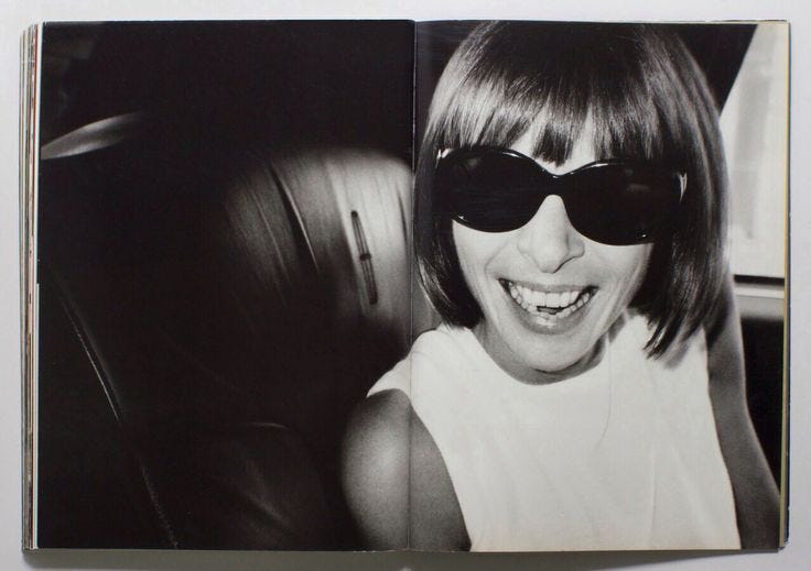 This may contain: a black and white photo of a woman wearing sunglasses