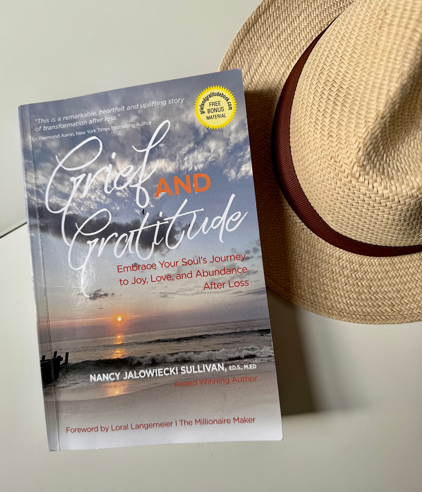 Book cover for Grief and Gratitude. Image is blue sky over rolling waves