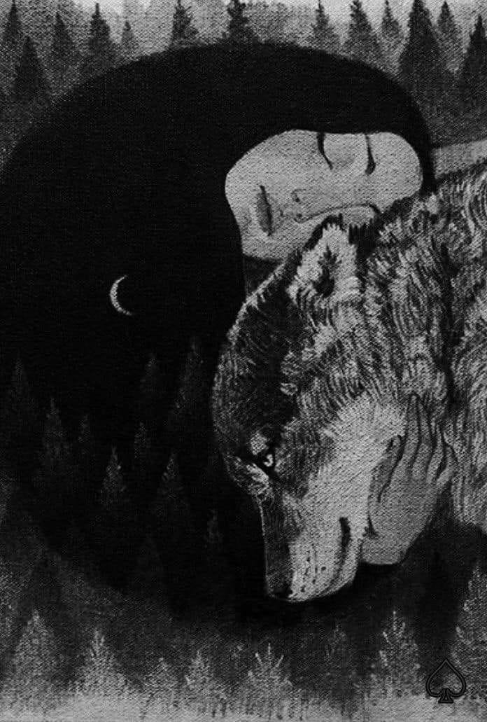 A woman with long black hair rests her head on the head of a wolf she is embracing. Pine trees are in the background and a present moon appears on her clothing. A woman with long black hair rests her head on the head of a wolf she is embracing. Pine trees are in the background and a present moon appears on her clothing.