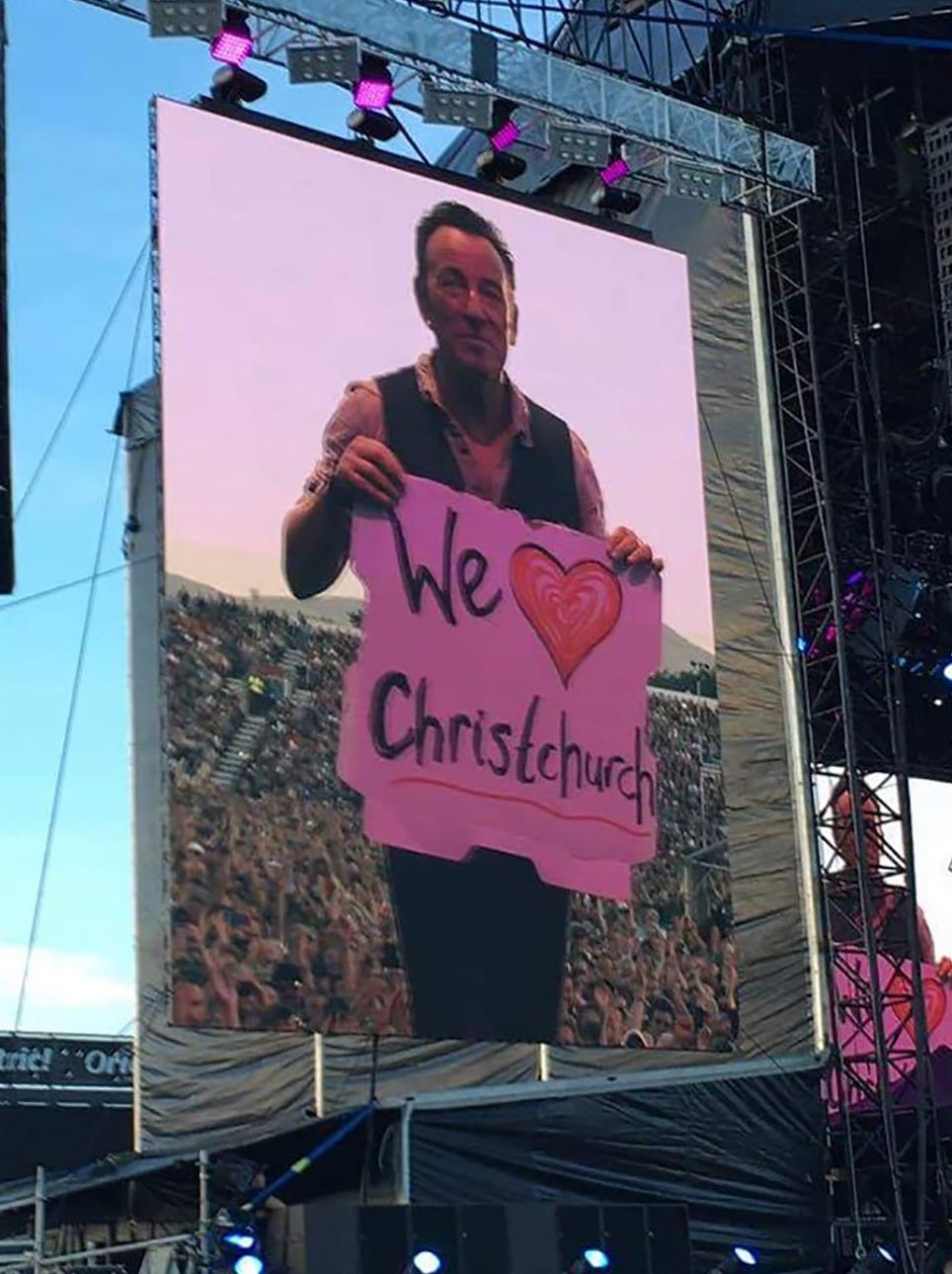 Bruce Springsteen held up a We love Christchurch sign, to applause from the crowd. Photo / Tania Gibson Bruce Springsteen held up a We love Christchurch sign, to applause from the crowd. Photo / Tania Gibson