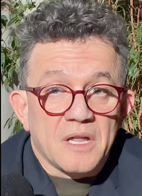 Berat Buzhala speaking on 27 February 2026, one day after the opening of Hashim Thaçi’s obstruction trial in The Hague. The expression oscillates between composure and strain, as he reflects publicly on dismissing employees while the legal storm intensifies.