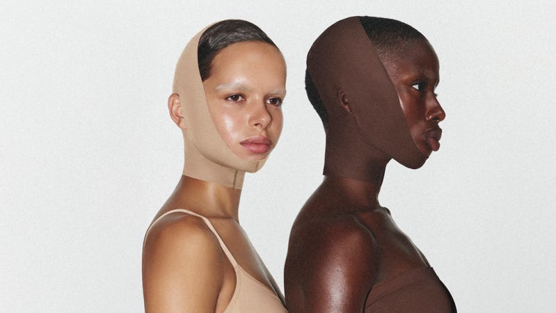 Two women wearing a face wrap that goes under their chins to the top of their heads