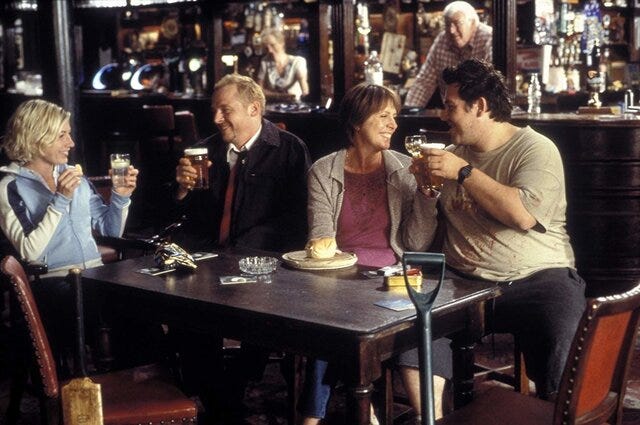 Still from Shawn of the Dead with Shawn imagining he's at the pub with his mom, Liz, and Ed in his first version of the plan to survive the zombies. Still from Shawn of the Dead with Shawn imagining he's at the pub with his mom, Liz, and Ed in his first version of the plan to survive the zombies.