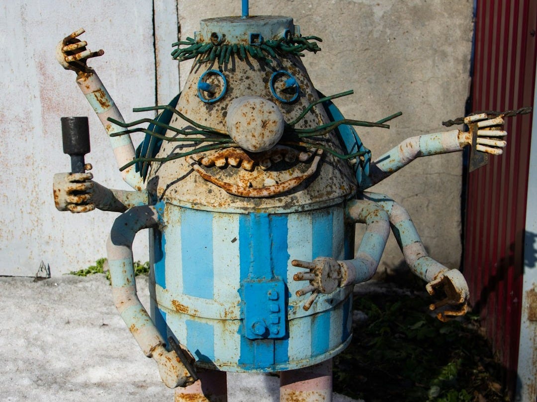 a blue and white robot statue with arms and legs