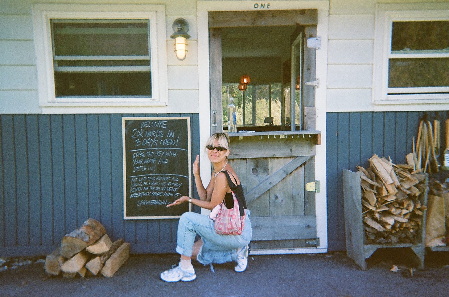 Nicole's sister with the Spruceton Inn chalkboard welcoming us to the 20K words in 3 days retreat