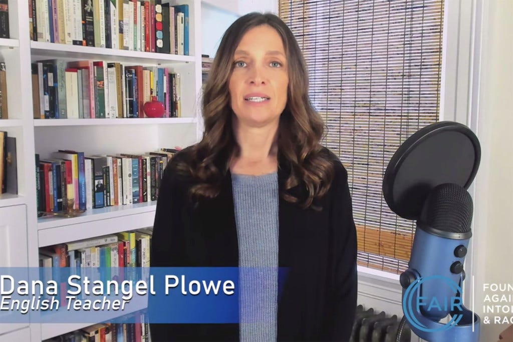 Dana Stangel Prowe, an English Teacher, stands in front of a bookshelf, speaking into a microphone. Dana Stangel Prowe, an English Teacher, stands in front of a bookshelf, speaking into a microphone.