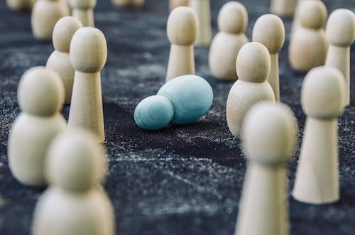 Free Wooden figures placed among fallen representing concept of breakdown during fight against public opinion and social order Stock Photo