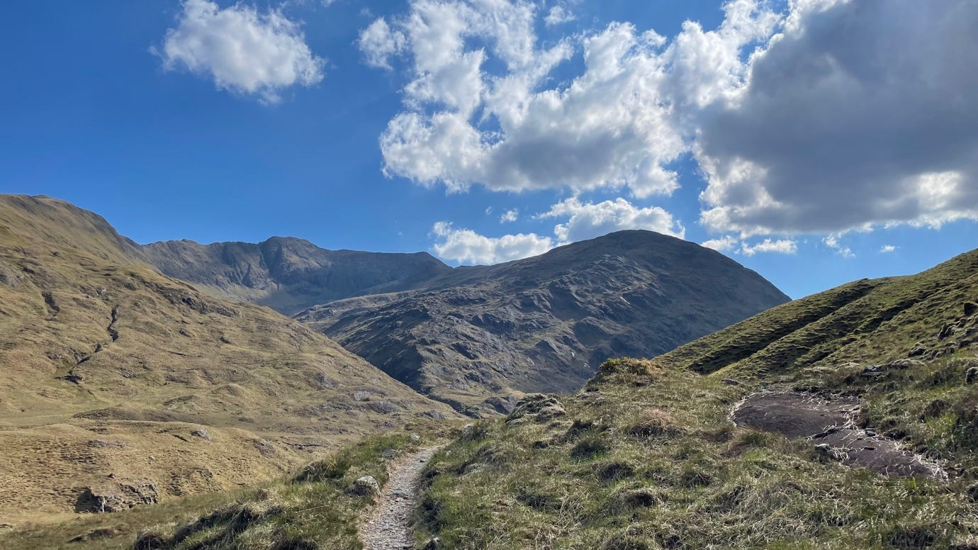 A person walking on a trail in a grassy area

AI-generated content may be incorrect.