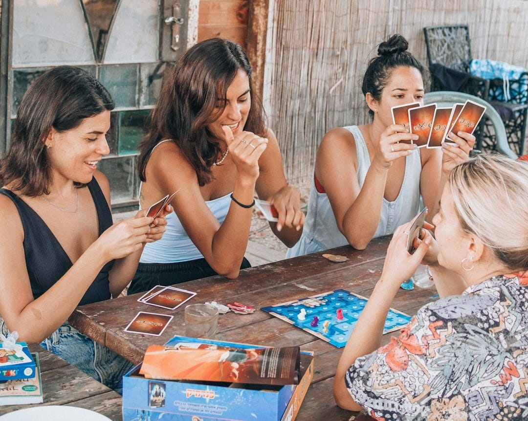 a group of people sitting at a table eating food